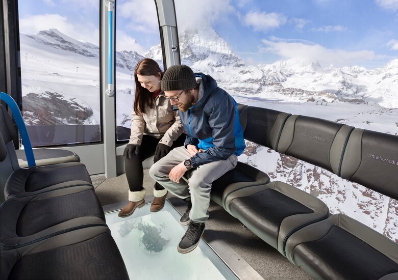 Zwei Leute die durch den Glasboden schauen | © Zermatt Bergbahnen AG