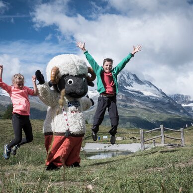 kids having fun with mascot Wolli