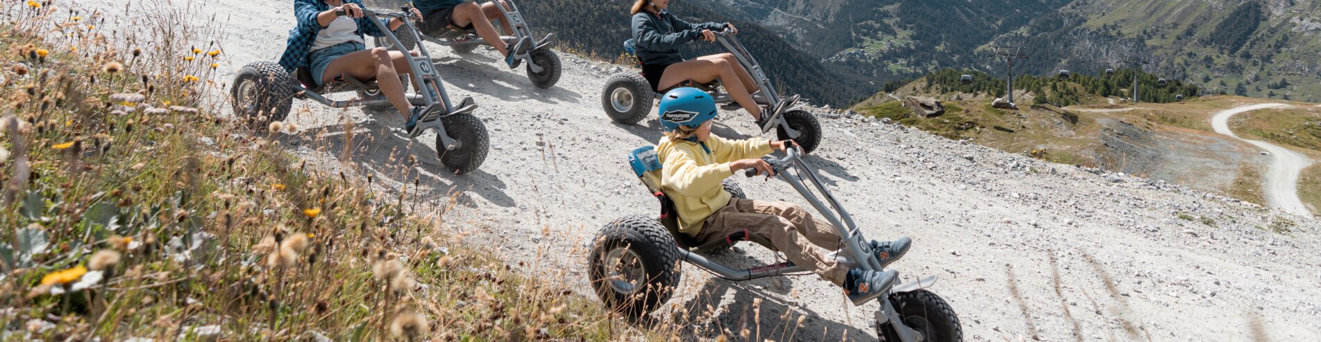 Mountaincart from Blauherd to Sunnegga | © BasicHomeProduction vier Freunde beim Fahren von Mountaincarts vor dem Matterhorn | © BasicHomeProduction